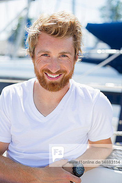Young man on sailboat at Chiemsee lakeside  portrait  Bavaria  Germany