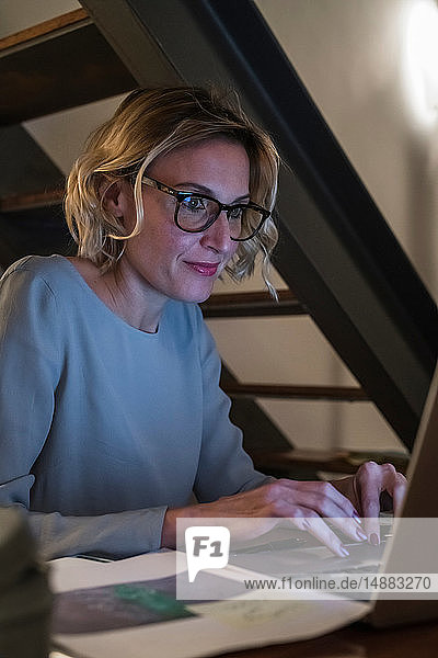 Woman working at laptop in home office