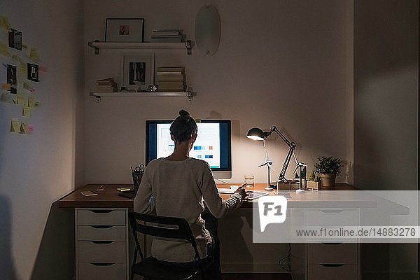 Woman working late at home