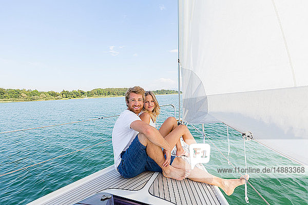 Young couple sailing on Chiemsee lake  portrait  Bavaria  Germany
