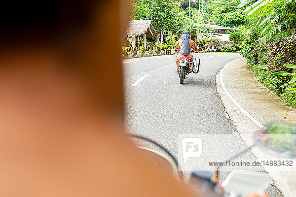Men on motorbike road trip  Pagudpud  Ilocos Norte  Philippines
