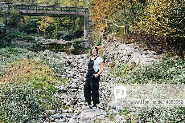 Woman standing in dry riverbed  Rezzago  Lombardy  Italy