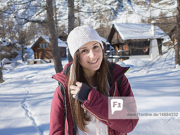 Young woman in knit hat in snow covered forest  portrait  Alpe Ciamporino  Piemonte  Italy