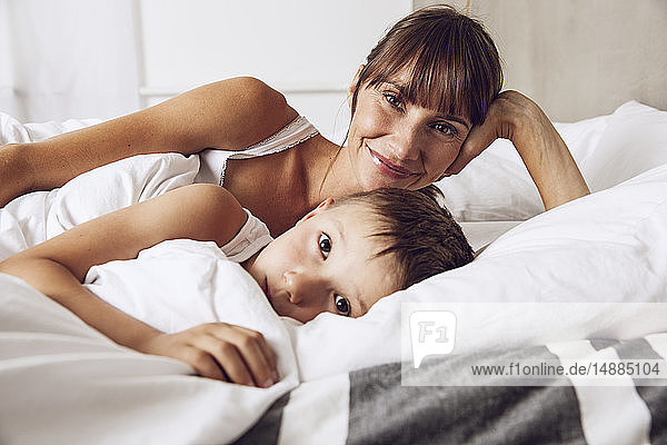 Mother and son cuddling in bed