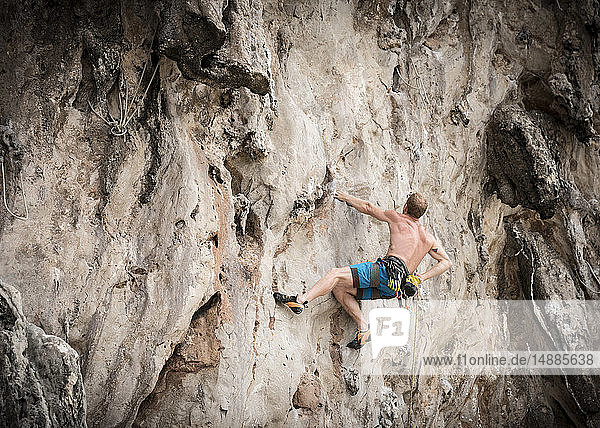 Thailand  Krabi  Lao Liang  barechested climber in rock wall