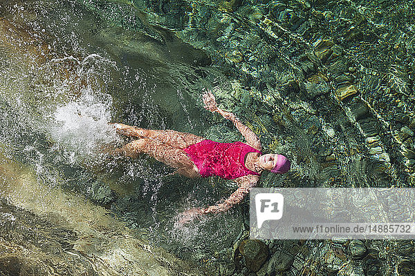 Switzerland  Ticino  Verzasca Valley  woman swimming in refreshing Verszasca river