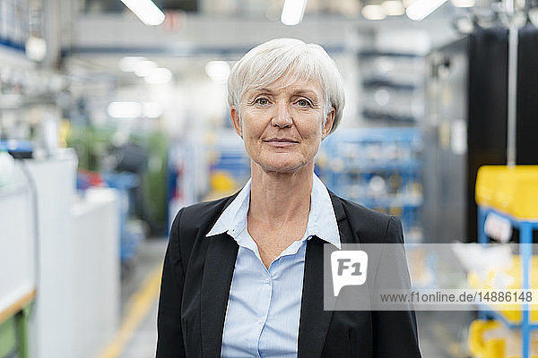 Portrait of confident senior businesswoman in a factory
