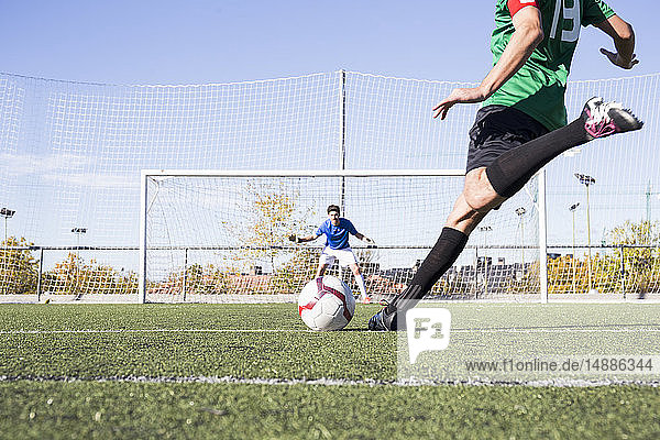 Football player shooting the ball on football field