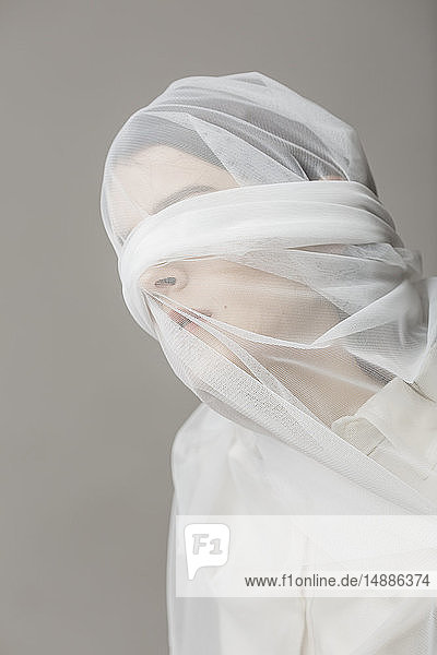 Blindfold woman  wrapped in a veil