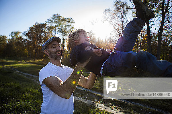 Father playing with his little son outdoors