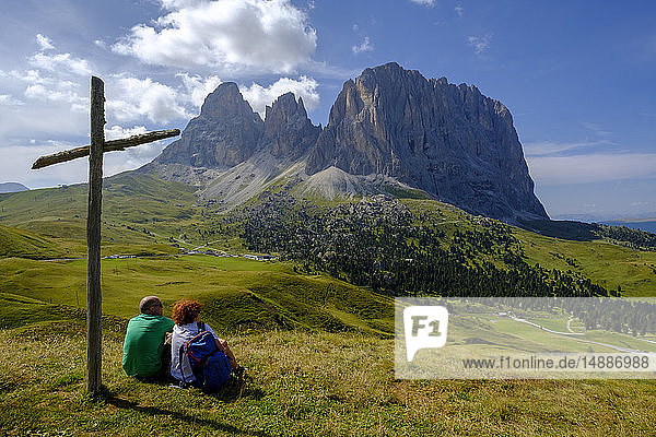 Italy  South Tyrol  Sella group  hiker sitting at summit cross