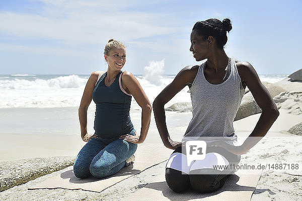 Zwei Frauen bei einer Gymnastikübung am Strand