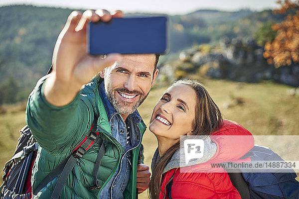 Glückliches Paar auf einer Wanderung in den Bergen mit einem Selfie