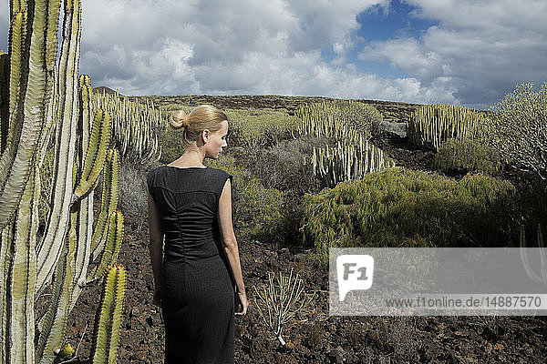 Spain  Tenerife  Malpais de Guimar  woman in volcanic landscape with cacti