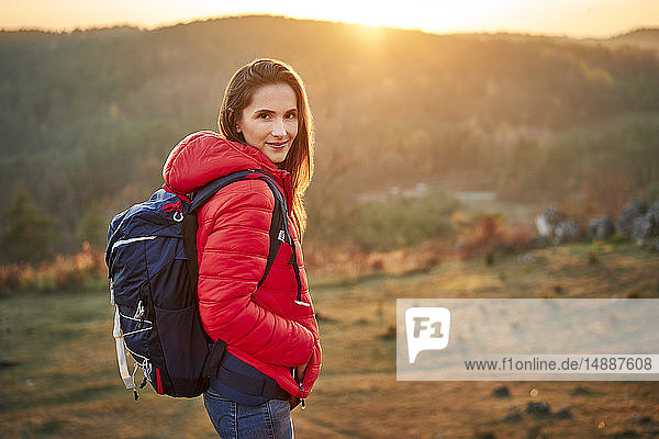 Portrait of smiling woman on a hiking trip in the mountains
