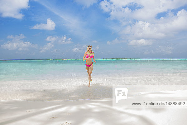 Beautiful woman running on a dream beach