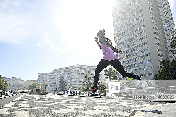Sportive woman jumping outdoors