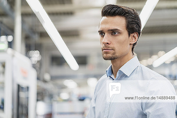 Portrait of a serious businessman in a factory