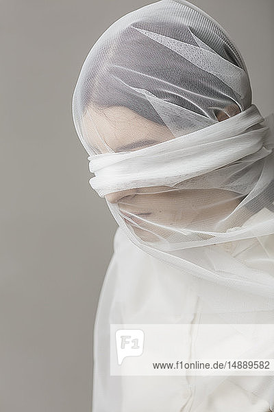 Blindfold woman  wrapped in a veil