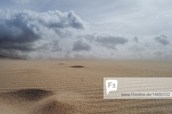 Spain Tarifa cloudy sky over sand dune