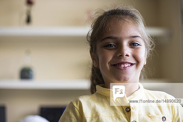 Portrait of smiling little girl at home