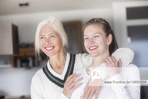 Portrait of happy mother embracing her adult daughter