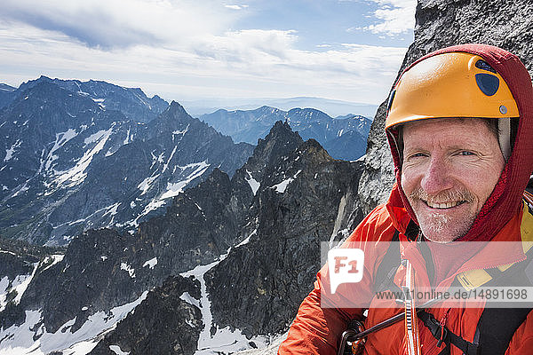 Mature man mountain climbing on Mount Stuart in North Cascade Mountains  Washington  USA