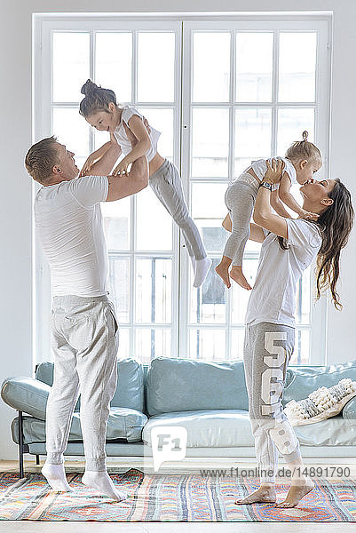 Parent lifting daughters by window