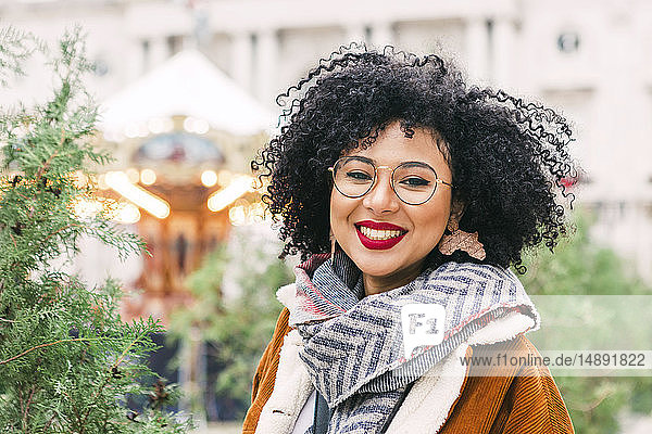 Portrait of smiling young woman wearing glasses and red lipstick