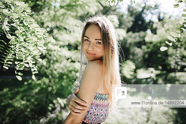 Young woman smiling in park