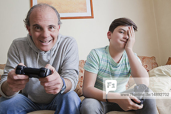 Father and teenage son playing video game