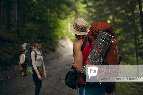 Couple hiking in forest at the Carpathian Mountain Range  Ukraine