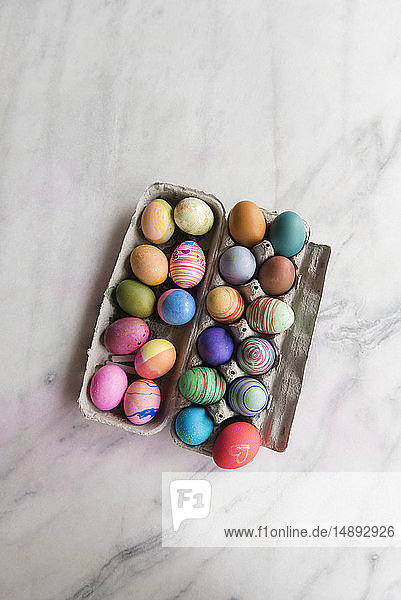 Dyed eggs in carton
