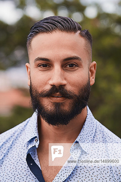 Portrait of confident bearded man at party
