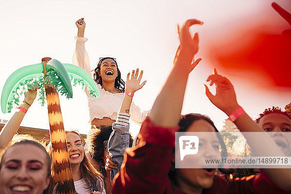 Fröhliche junge enthusiastische Fans genießen Musikfestival