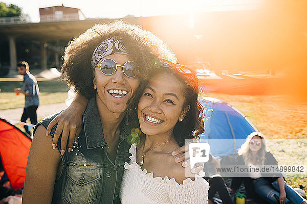 Portrait of smiling friends enjoying at music festival during summer