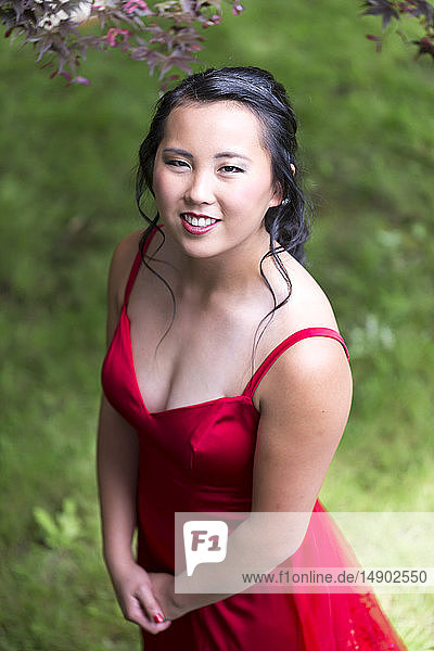 Portrait of a young woman in a red formal dress; Chilliwack  British Columbia  Canada