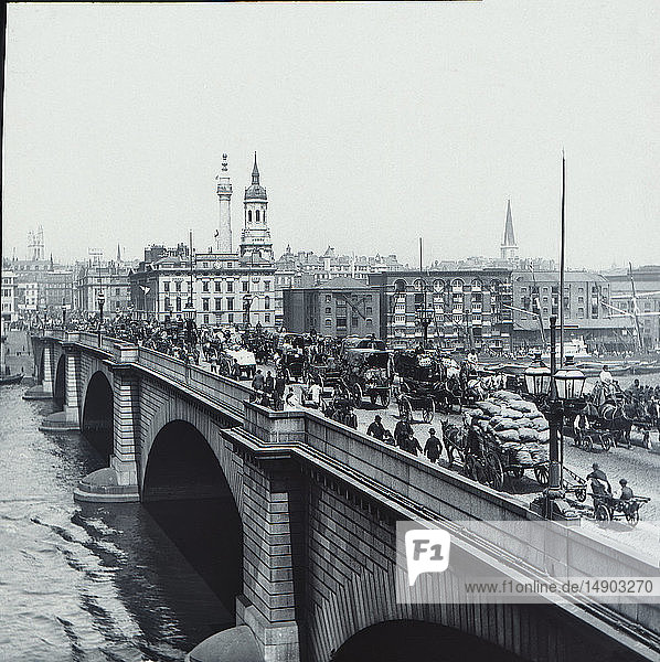 Magic lantern slide circa 1880.Victorian/Edwardian.Social History. Slide set: A slide fromt he seires Here and there about London  published in 1880. London Bridge busy and full of horses wagons and people about their daily work