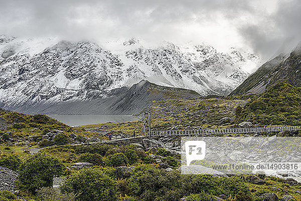 Schneebedeckte Berge und Hängebrücke entlang des Hooker Valley Track  Mount Cook National Park; Südinsel  Neuseeland