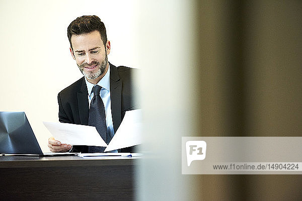 Businessman reading documents in office
