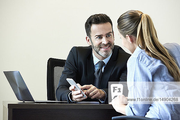 Businessman and businesswoman having meeting in office