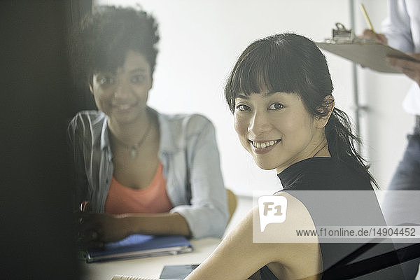 Smiling businesswomen sitting in office