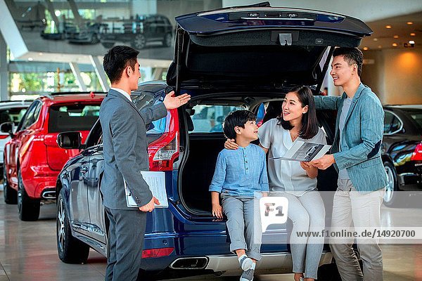 Car sales staff and customers