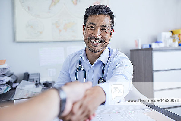 Point of view happy doctor shaking hands with patient