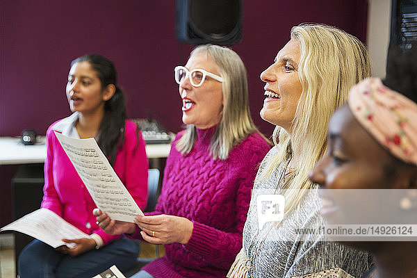 Womens choir singing in music recording studio