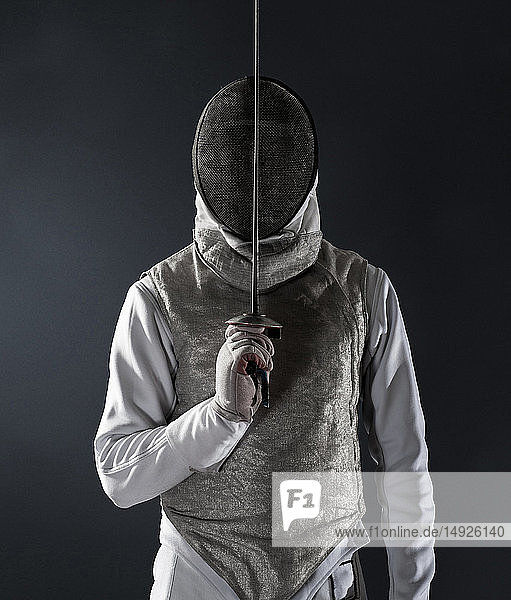 Portrait man in fencing uniform and mask