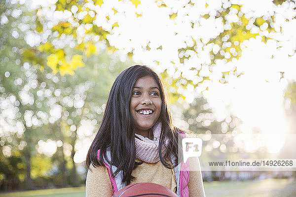 Smiling girl in autumn park
