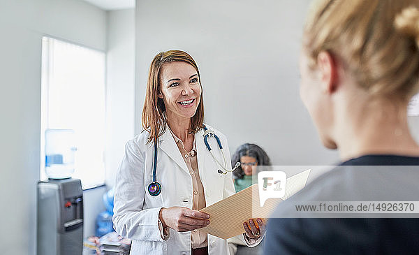 Female doctor and nurse talking in clinic