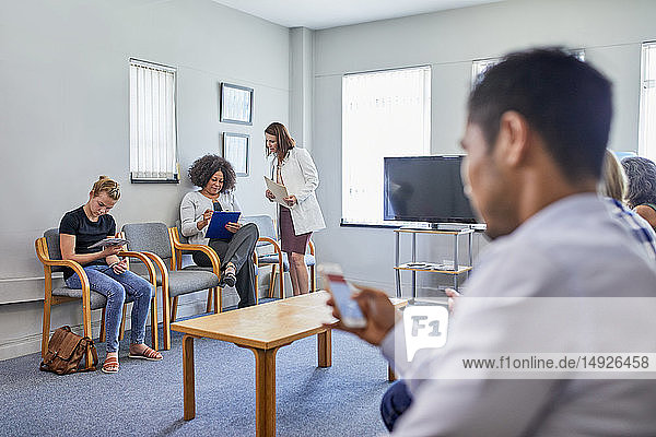 Doctor and patients in clinic waiting room