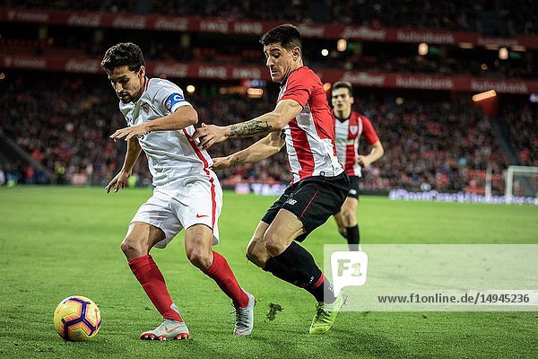 Jesus Navas (L) and Yuri Berchiche (R) dispute the ball during a Spanish League match between Athletic Club Bilbao and Sevilla FC at San Mames Stadium on January 13  2019 in Bilbao  Spain